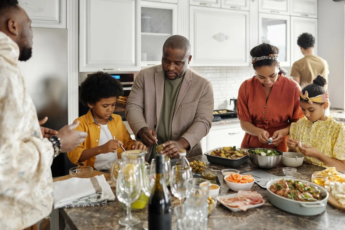 Family members preparing food together in a kitchen